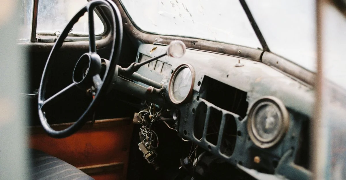 Découvrez le charme nostalgique du tableau de bord et du volant d'une voiture vintage.
